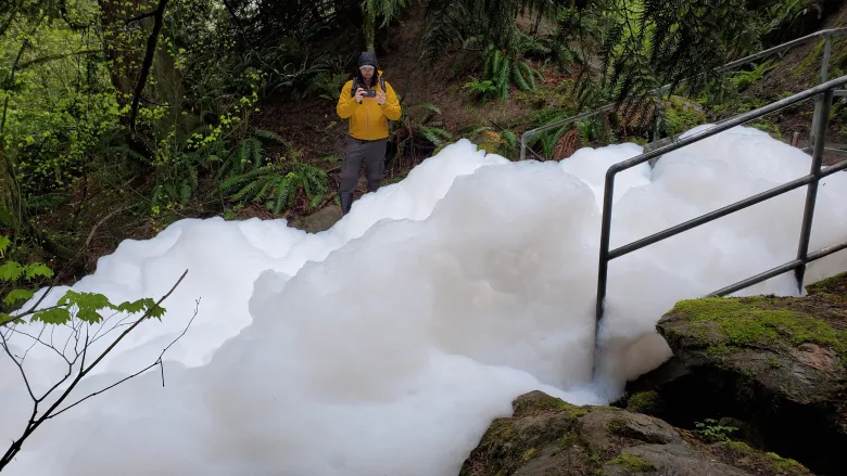 huge foam forming from detergent being washed into a stream