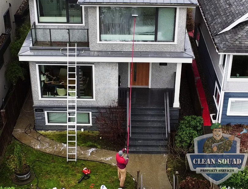cleaning windows with a water fed pole on a home in kitsilano vancouver