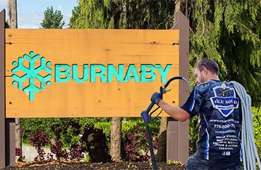 clean squad property services team member at burnaby sign